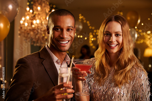 Portrait Of Couple With Drinks Enjoying Cocktail Party