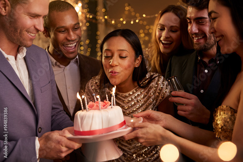 Canvas Print Woman Blowing Out Candles On Birthday Cake