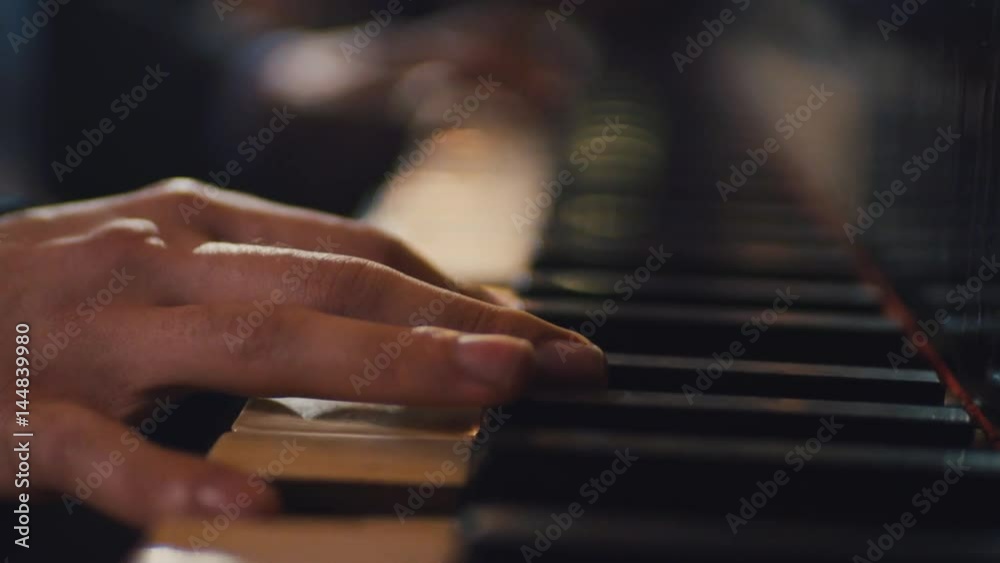 Close up view of male pianist hands playing the piano. Acoustic performance, being talented. Having fun. Close up view of male pianist hands playing the piano. Acoustic performance, being talented. Having fun.