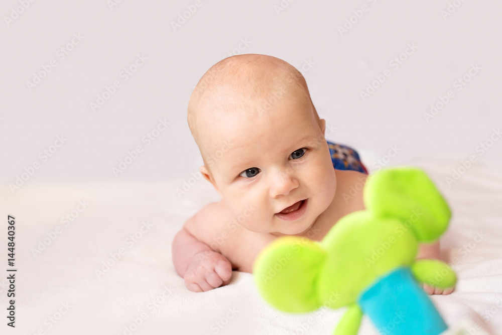 Baby playing and smiling with a toy Baby playing and smiling with a toy