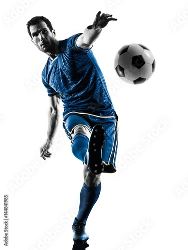 one caucasian soccer player man playing kicking in silhouette isolated on white background