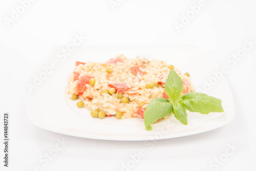Risotto with tomato and pea on a white background