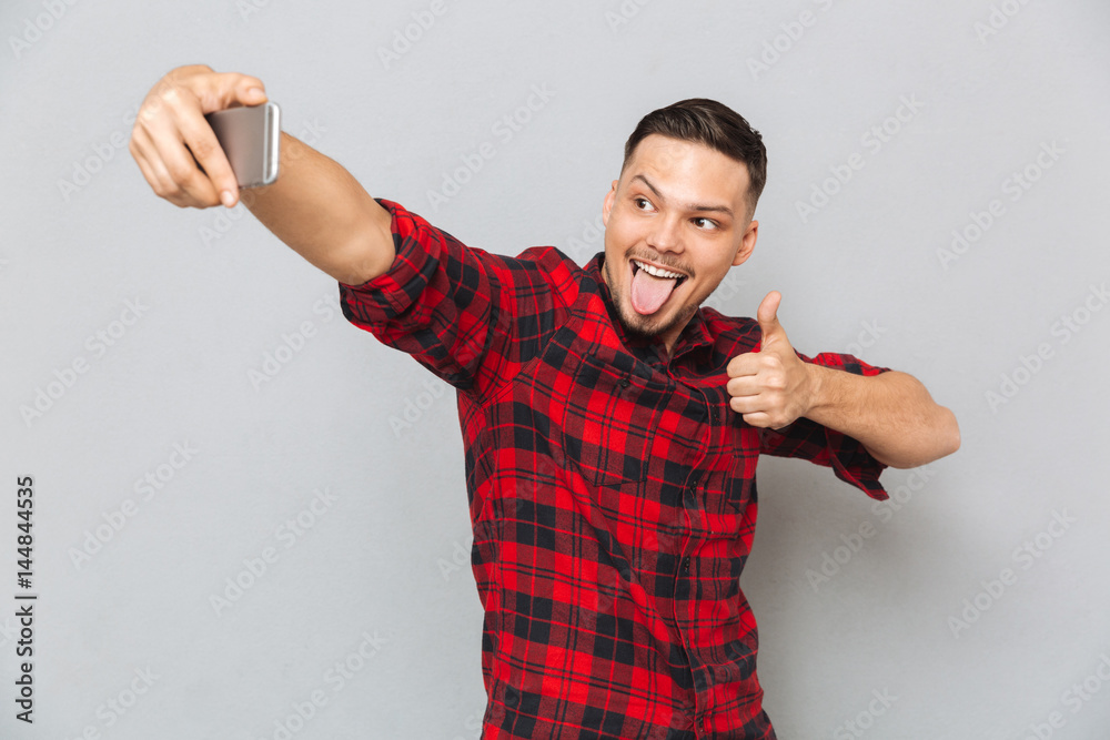 Happy casual man in plaid shirt making selfie Happy casual man in plaid shirt making selfie