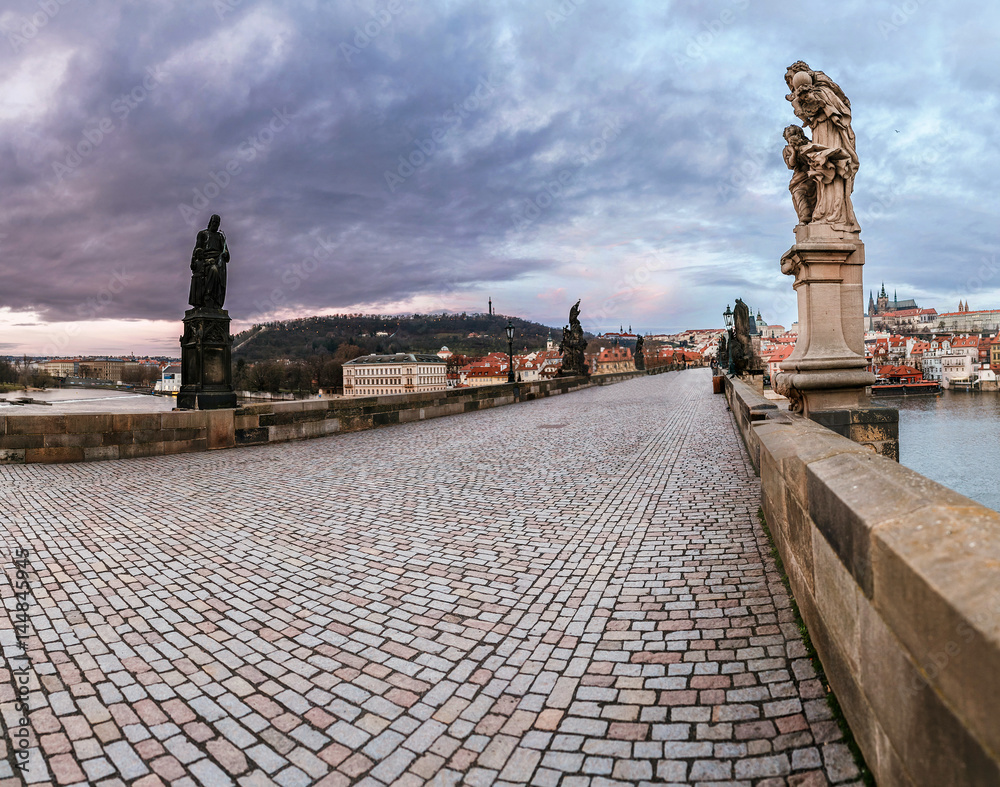 Panorama of Charles bridge in Prague with statues and Towers at early morning