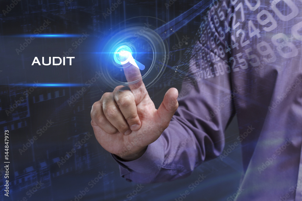 Fototapeta premium Business, Technology, Internet and network concept. Young businessman working on a virtual screen of the future and sees the inscription: Audit