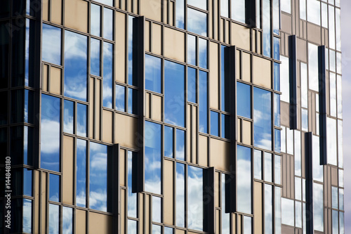 Perspective and underside angle view to textured background of modern glass building skyscrapers