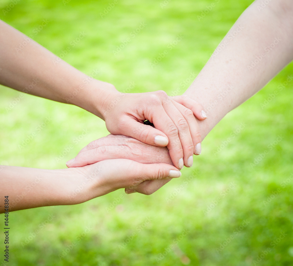 Young hands holding old age hands