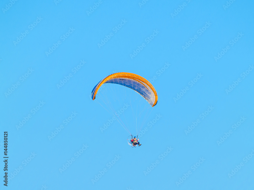 A man practicing extreme sport with paraglider with motor A man practicing extreme sport with paraglider with motor