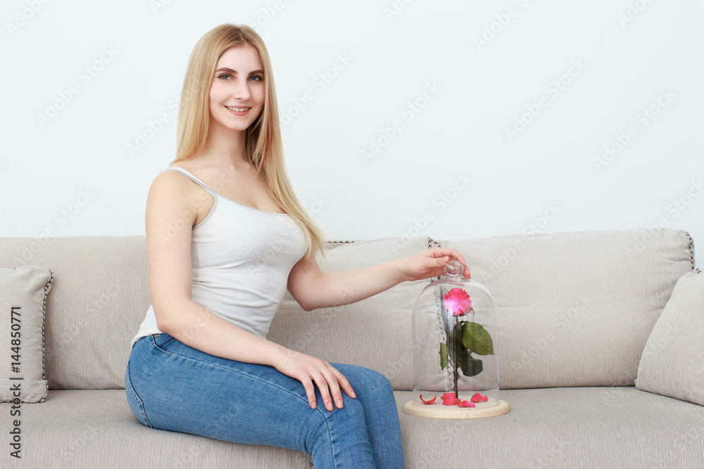 Girl with flower. Beautiful young woman holding rose Girl with flower. Beautiful young woman holding rose