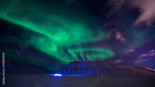 The polar Northern lights in the mountains of Svalbard  Longyearbyen  Spitsbergen  Norway wallpaper