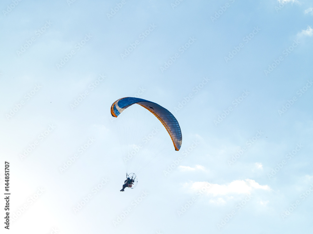 A man practicing extreme sport with paraglider with motor A man practicing extreme sport with paraglider with motor