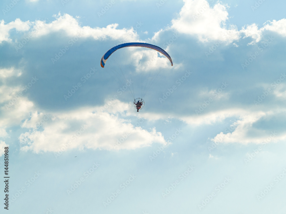 A man practicing extreme sport with paraglider with motor A man practicing extreme sport with paraglider with motor