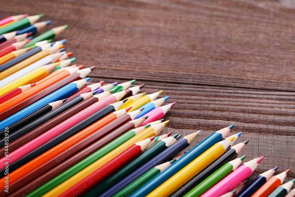 Drawing colourful pencils on brown wooden table Drawing colourful pencils on brown wooden table