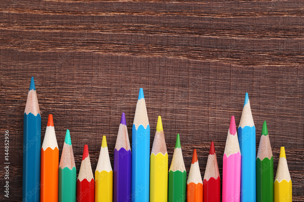 Drawing colourful pencils on brown wooden table Drawing colourful pencils on brown wooden table