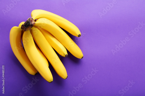 Sweet bananas on the purple background