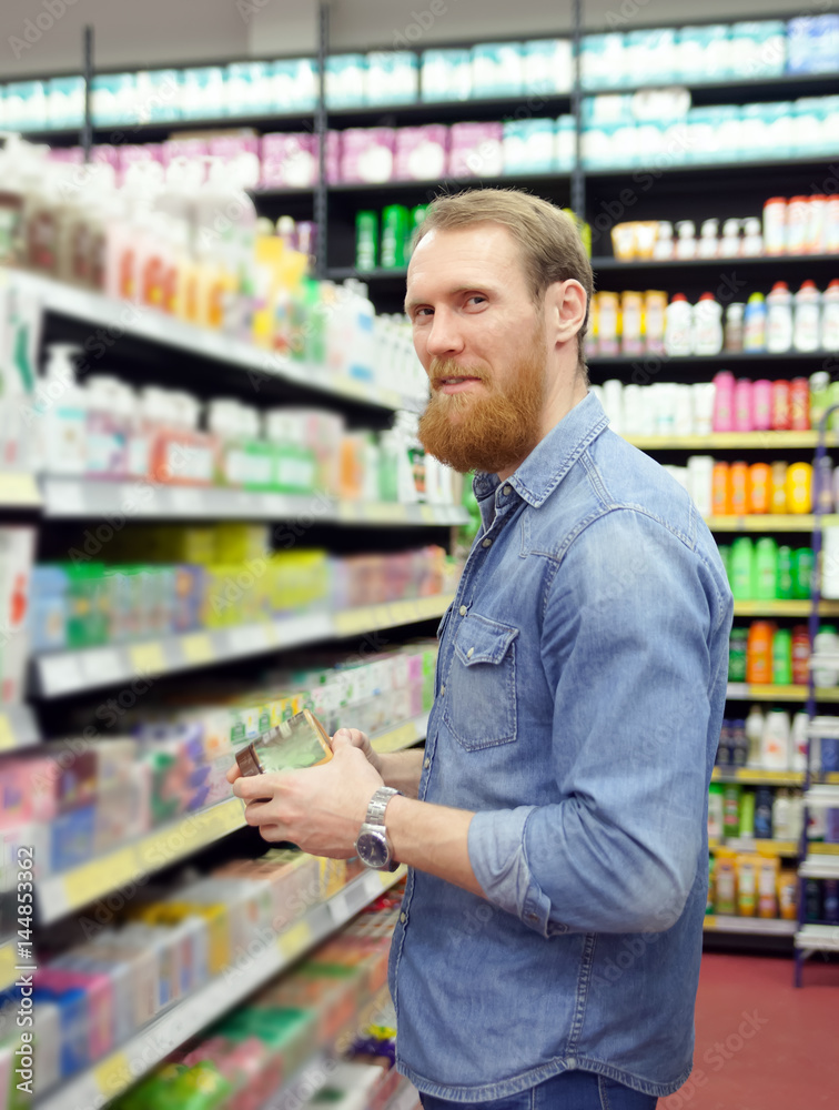man choosing products for body care
