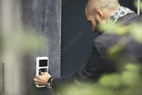 Businessman entering security code to open office door photo