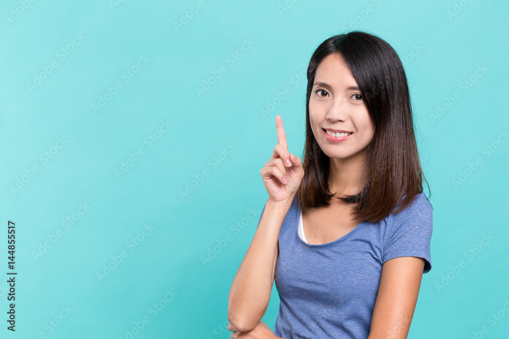 Young woman showing finger point up