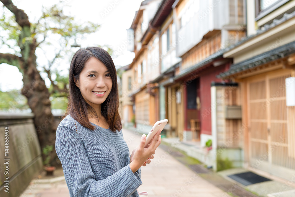 Young woman visit kanazawa and using mobile phone Young woman visit kanazawa and using mobile phone