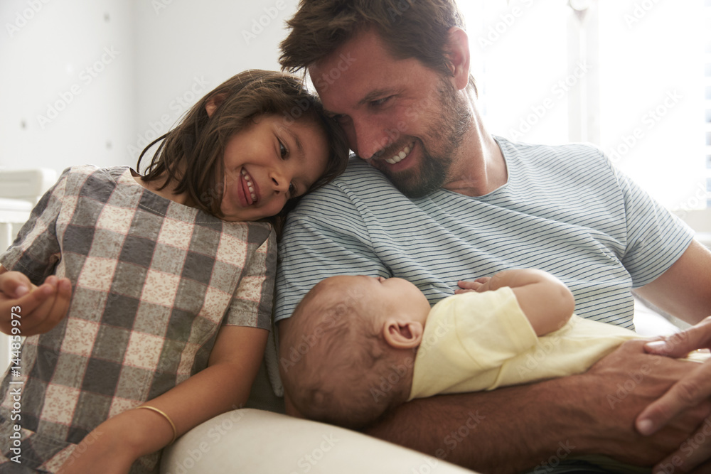 Father With Daughter And Newborn Son In Nursery Father With Daughter And Newborn Son In Nursery