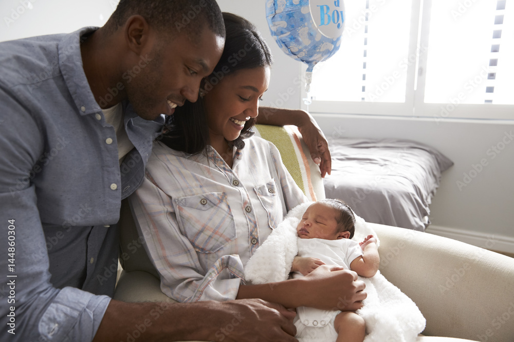 parents-home-from-hospital-with-newborn-baby-in-nursery-stock-photo