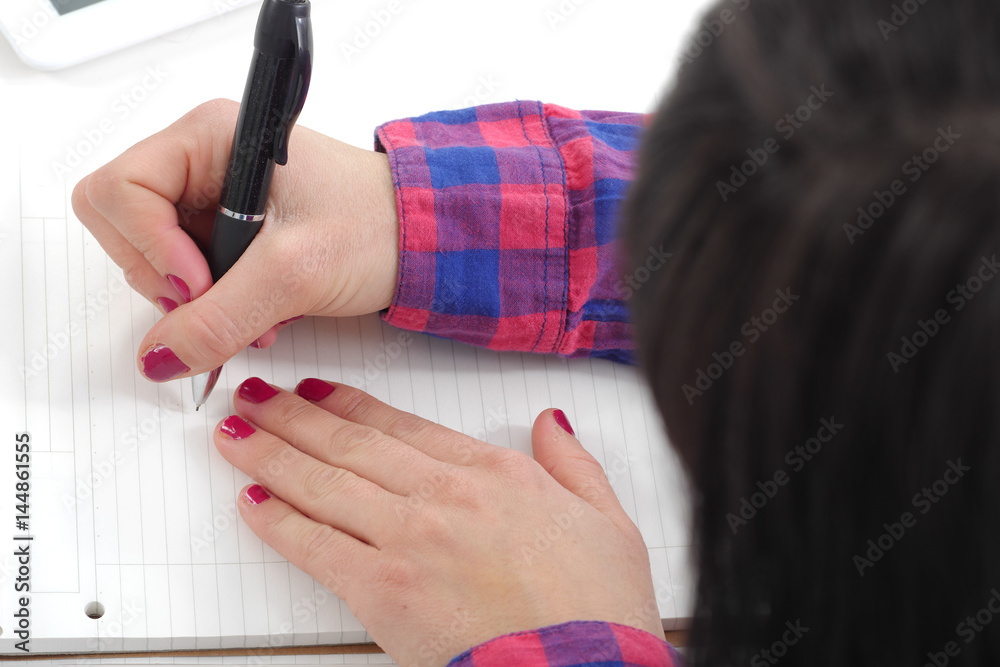 © Philipimage - close up of hand of woman taking notes