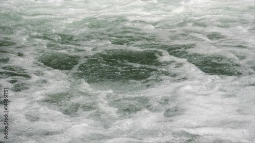 Super slow motion water floating down a cascade of a river, close, in HD photo