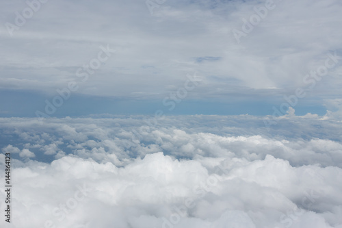 Aerial view on clouds and blue sky from airplane window © Glebstock