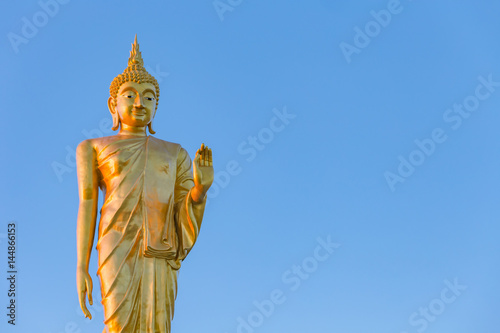 The standing buddha statue on blue sky  located in Chanthaburi  Thailand.