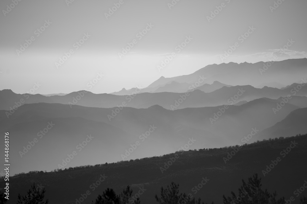 Mountains in sunrise light in black and white