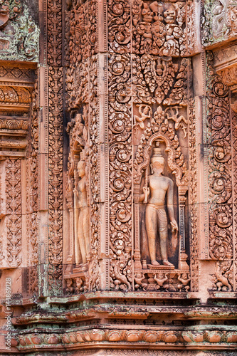 Carve of devata on the red sandstone walls in Banteay Srei, Siem reap, Cambodia.