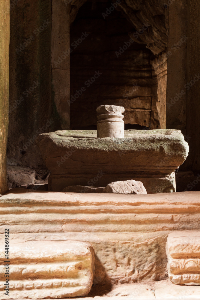 The sacred stone lignum and yoni sculpture in the Bayon temple, Angkor Thom, Cambodia. The cylindrical stone is believed to have male power and the surrounding, larger stone is female. The sacred stone lignum and yoni sculpture in the Bayon temple, Angkor Thom, Cambodia. The cylindrical stone is believed to have male power and the surrounding, larger stone is female.