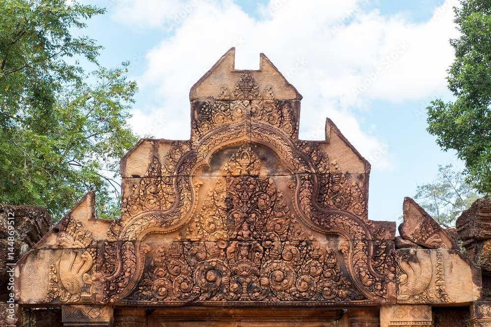 Obraz premium Ancient isosceles pink stone Carving of kala, mythical creature representative of time and of the god Siva in Banteay Srei, Siem reap, Cambodia.