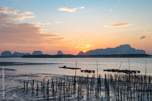 Landscape of riverside with mountains behind during the sunrise.