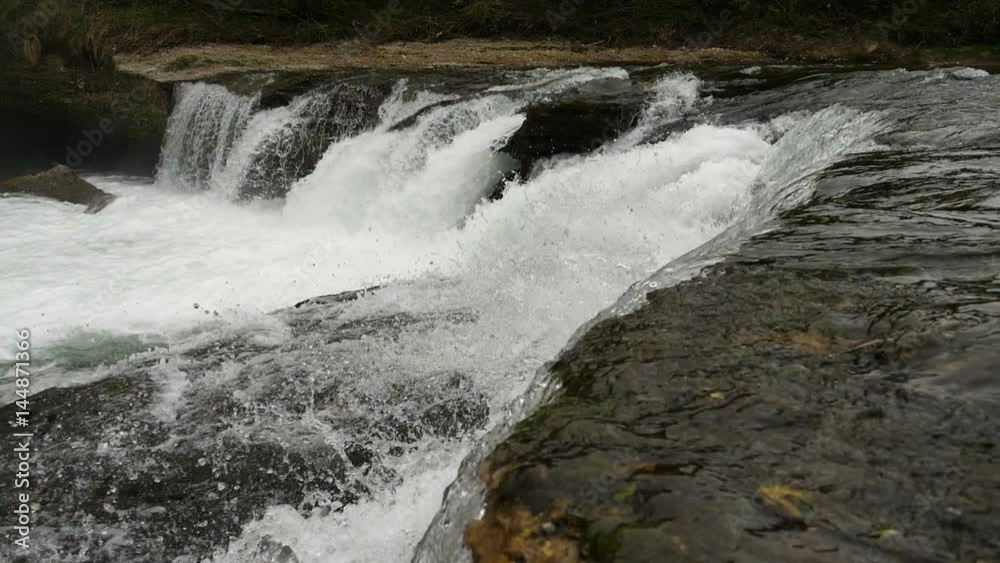 Wide shot of super slow motion water floating down a cascade of a river, in HD Wide shot of super slow motion water floating down a cascade of a river, in HD