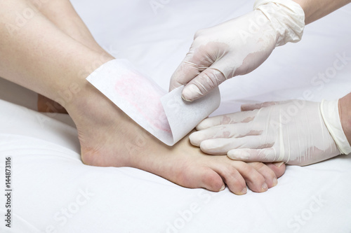 Process depilation female legs and hands in a beauty salon © lester120
