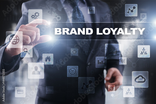Businessman selecting brand loyalty on virtual screen.