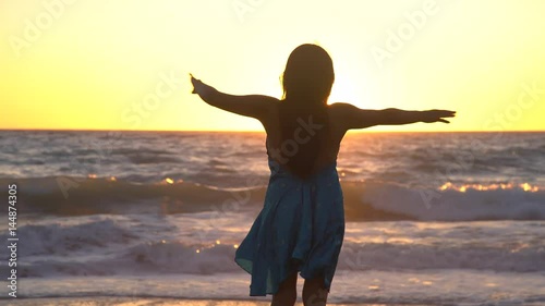 relaxing woman in a sunset at a beach. photo