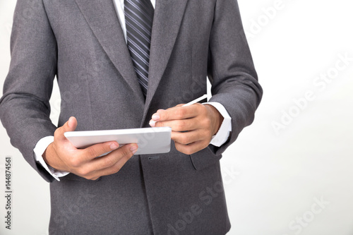 young asian startup entrepreneur businessman wearing gray suit using digital tablet touchpad with touch pen over white background