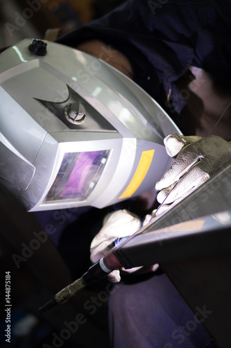 Closeup of man wearing mask welding in a workshop