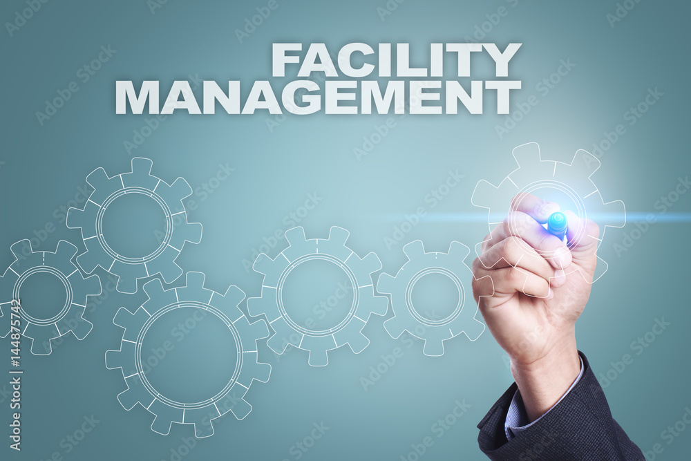 Businessman drawing on virtual screen. facility management concept