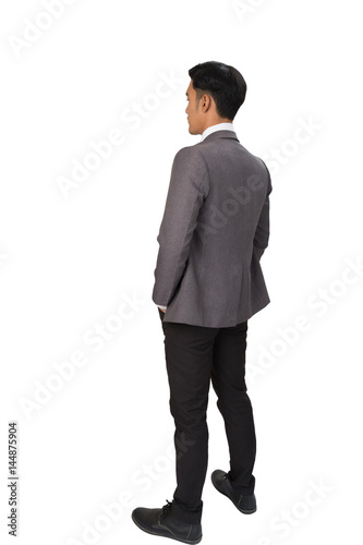 Thoughtful businessman standing back to camera on white background