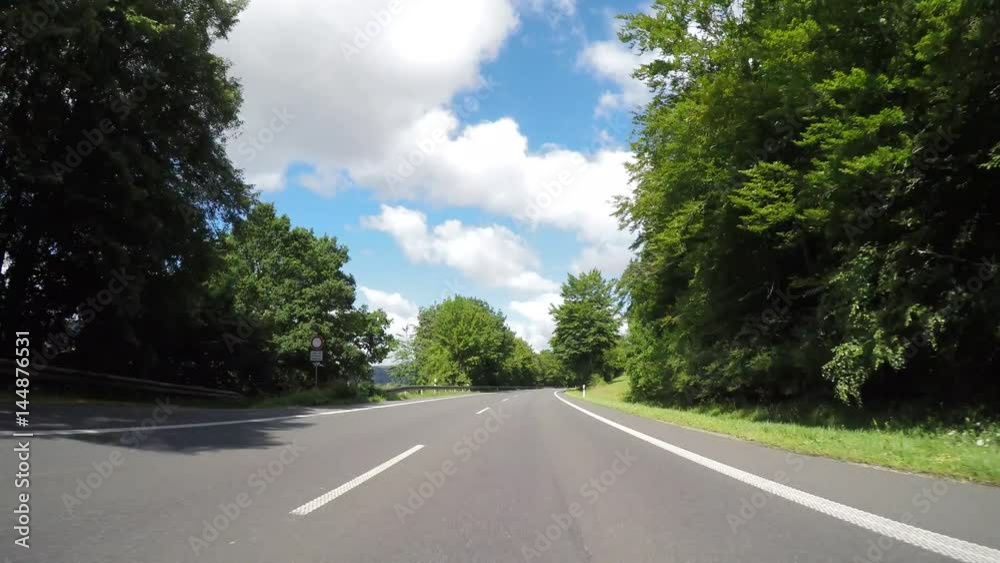 P.O.V. - Driving on country road in summer in germany (Drivers view).  from a on-board-camera