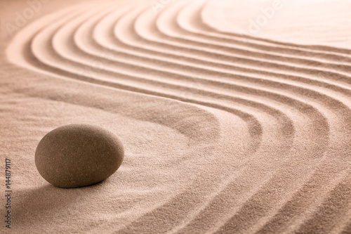 Zen stone and sand garden for Buddhism meditation or a spa wellness backgroudn with copy space.