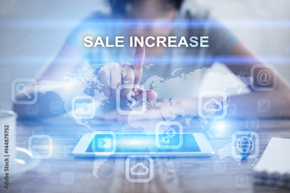 Woman using tablet pc, pressing on virtual screen and selecting sale increase Woman using tablet pc, pressing on virtual screen and selecting sale increase