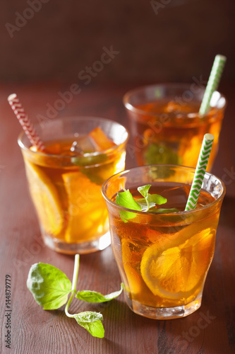ice tea with lemon and mint on dark rustic background