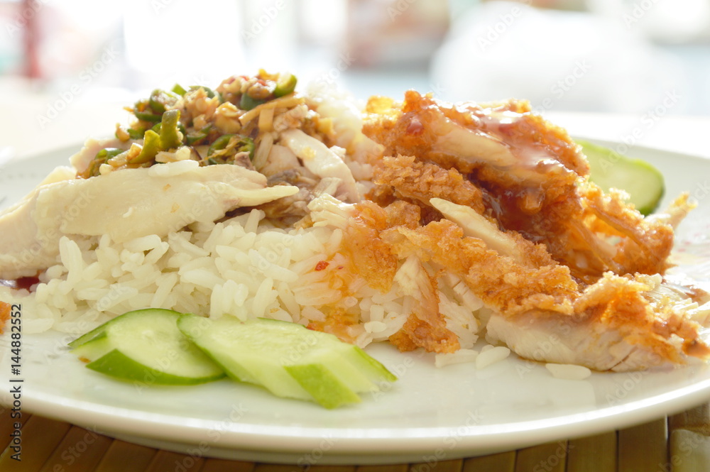 crispy deep fried and boiled chicken on cooked rice dressing different sauce on plate crispy deep fried and boiled chicken on cooked rice dressing different sauce on plate