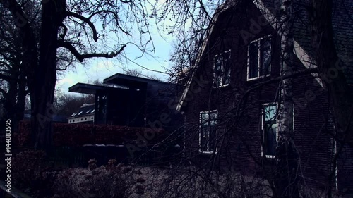 Horror abandoned house in old european city, dark creepy shot