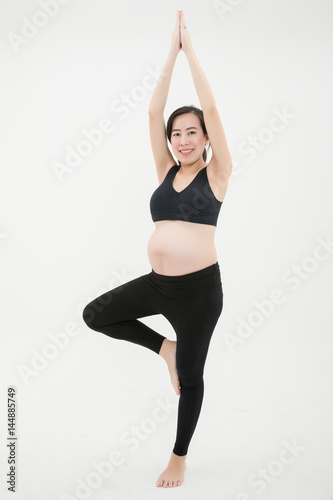 Pregnant Woman Standing and Playing Yoga