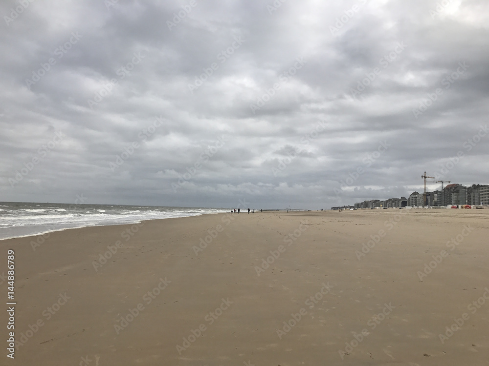 Long empty sandy beach on a cold overcast day Long empty sandy beach on a cold overcast day